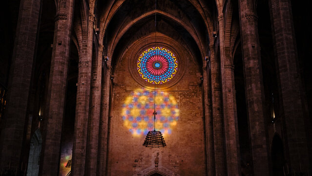 Stained glass rose window illuminating Gothic cathedral architecture