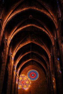 Gothic cathedral interior with vaulted ceiling and rose window
