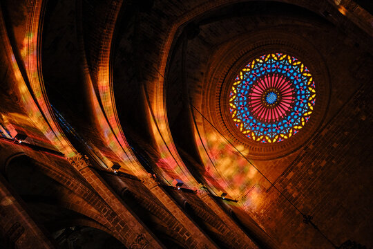 Stained glass rose window illuminating Gothic cathedral architecture