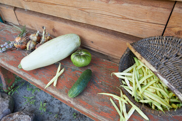 Autumn harvest, vegetables and fruits lie on a wooden table.