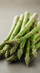 Close-up of Fresh Green Asparagus Spears Grouped on Gray Surface for Healthy Cooking and Nutrition Concept