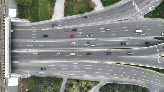 Top-down aerial drone view of a complex highway junction, overpasses and railway lines with traffic in Baku, Azerbaijan