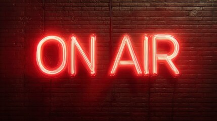 Illuminated neon sign on a brick wall displays the words "ON AIR" in vibrant red, signaling an active broadcast