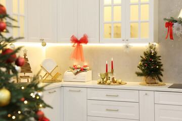 Christmas decor and glasses on countertop in kitchen. Interior design