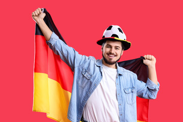 Male soccer fan with German flag on red background