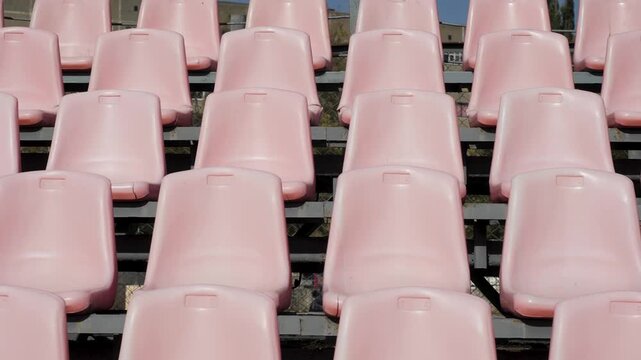 Yellow, green and white seats in row in stadium without the player and the audience. Empty stadium or race track seats