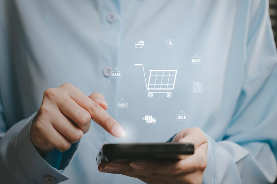 Mobile commerce concept, hand using smartphone with digital shopping cart icons, online retail system, e commerce transaction, payment security, omnichannel business