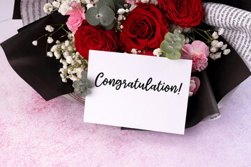 Red rose bouquet and congratulation card