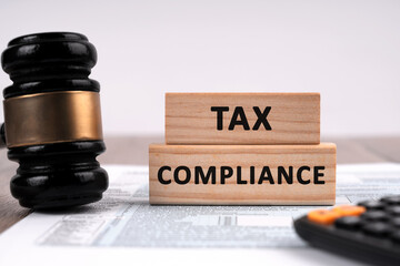 Gavel and wood block with text Tax Compliance