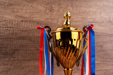 Close up of golden trophy with ribbon
