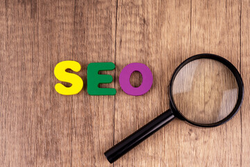 Magnifying glass and text SEO business concept