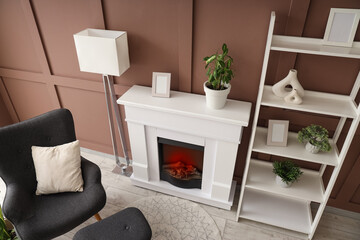 Fototapeta premium Interior of stylish living room with lamp, fireplace and armchair