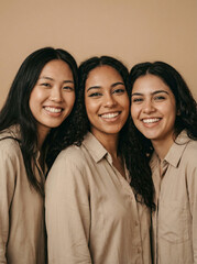 Three diverse women smile at the camera.