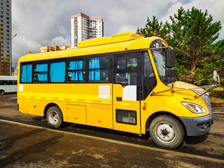 bright yellow school bus. clean and well-maintained school bus in an urban setting. For educational materials, transportation imagery, school promotional content, or urban lifestyle visuals