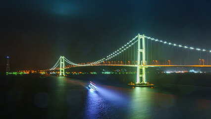 Muroran, Hokkaido, Japan - Oct 04 2024, panoramic view of the cable-stayed Hakucho Bridge, at night, Muroran, Japan