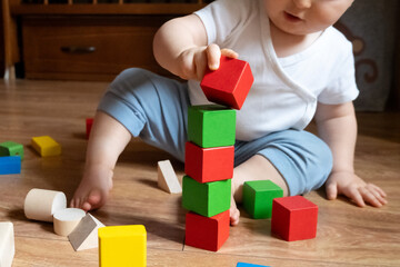 Baby Stacking Colorful Blocks on Wooden Floor