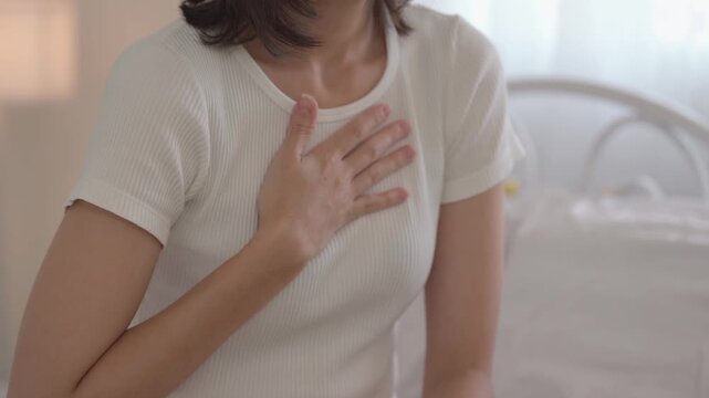 Close-up woman touching chest feeling pain heart attack symptom. disease, woman, pain, symptom, chest