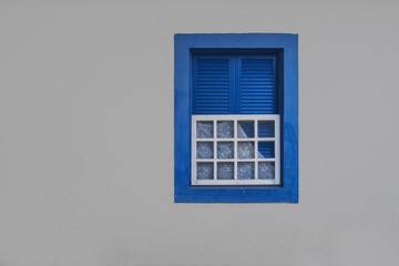 Fototapeta premium Blue colonial window in historic brazilian, architecture, minimalist facade photography, traditional brazil house exterior, pastel wall, travel aesthetic, cultural wall art