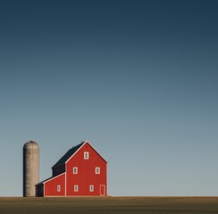 Red Barn and Silo in Open Farmland Under Clear Blue Sky with Copy Space for Farming, Sustainability, and Global Warming Concepts