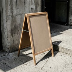 Blank wooden A-frame sidewalk sign mockup outside shop on concrete street