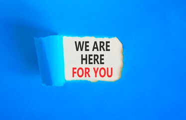 Support, help and we are here for you symbol. Concept words We are here for you on beautiful white paper. Beautiful blue paper background. Business we are here for you concept. Copy space.