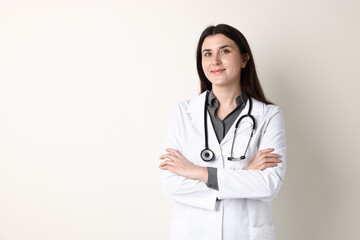 Fototapeta premium Doctor in medical uniform with stethoscope on white background, space for text