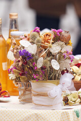 Close-up of dried flower bouquet with pinecones and natural decorations on market table at Naplavka farmers market in Prague during winter advent season.