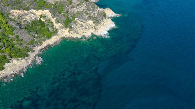 Cinematic Aerial Drone View of Paralia Dafni Beach in Zakynthos Greece with sandy shoreline turquoise Ionian Sea and dramatic coastal landscape