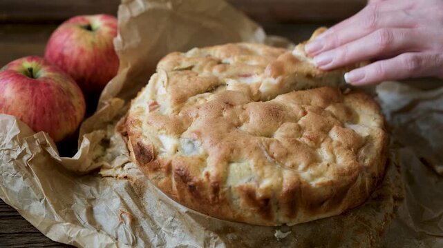 Homemade apple cake pie. Woman housewife hands cutting out slice of apple cake