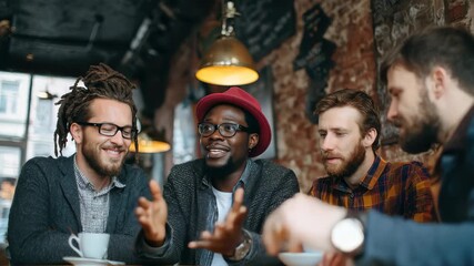 Group of men from diverse backgrounds engaging in conversation at a cozy cafe during the afternoon