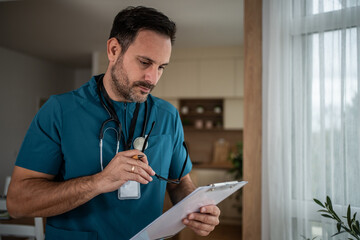 Doctor examining medical records holding clipboard glasses