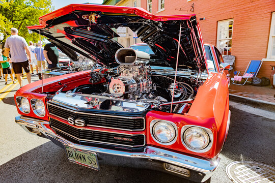 Muscle car classic Chevrolet Chevelle SS with raised hood at public auto exhibition in Leesburg.
