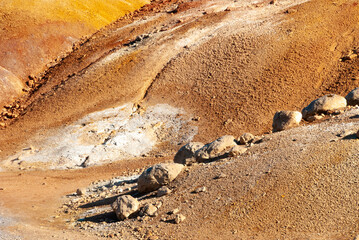 Obraz premium Krýsuvík is a vibrant geothermal area on Iceland's Reykjanes Peninsula, famous for its colorful, mineral-stained hills, bubbling mud pots, steaming fumaroles (steam vents), and hot springs.