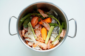 Overheard shot of shellfish stock on a white background	