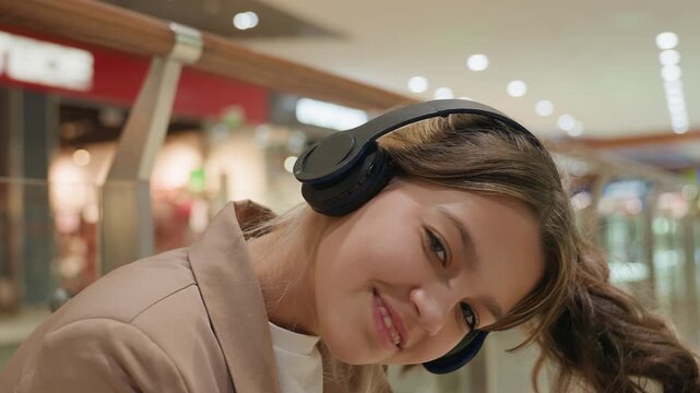 teen girl exploring store selections, teenage girl with headphones delightfully perusing shopping options, youthful female enthusiastically enjoying her time shopping and exploring stores
