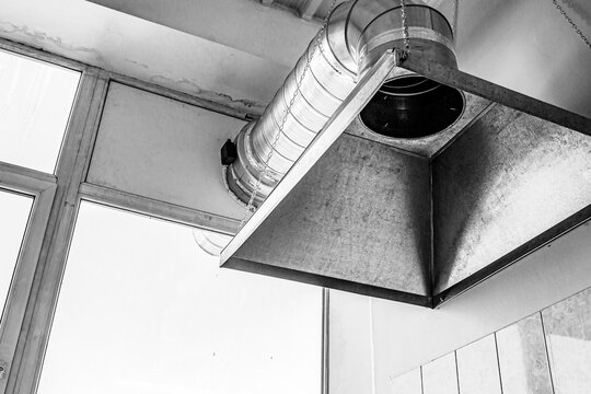 professional hood in a restaurant kitchen made of stainless steel with galvanized duct