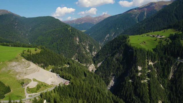 Aerial panoramic view around the village and mountains of Schmitten in Switzerland on a sunny day in summer.