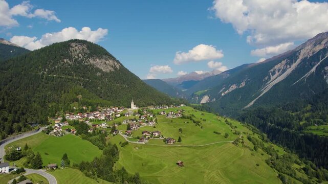 Aerial panoramic view around the village and mountains of Schmitten in Switzerland on a sunny day in summer.