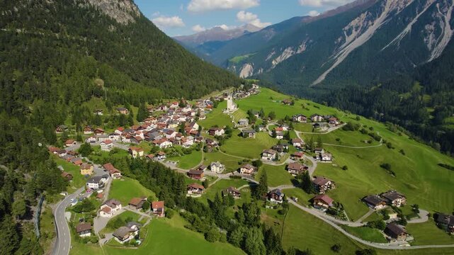 Aerial panoramic view around the village and mountains of Schmitten in Switzerland on a sunny day in summer.