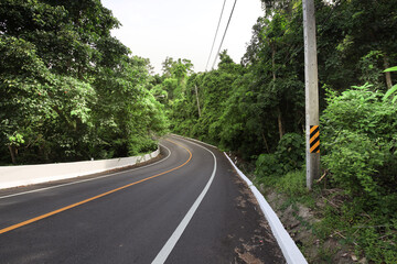 Road with a yellow and black sign on the side