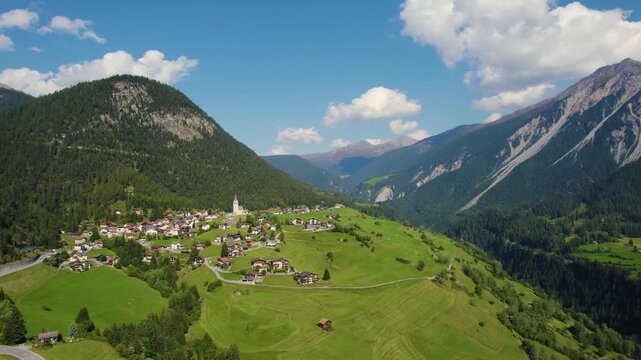 Aerial panoramic view around the village and mountains of Schmitten in Switzerland on a sunny day in summer.
