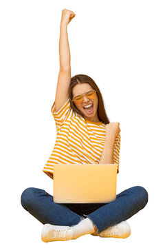 Fototapeta Happy young woman celebrating success with laptop, raising arms in excitement, sitting on floor