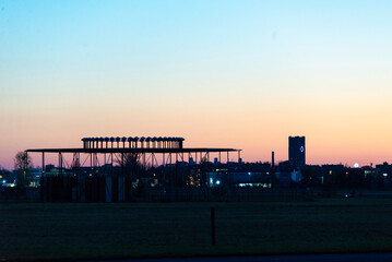 Silhouette of Airport Navigation Structure and City Skyline at Twilight in Berlin