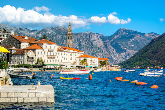 View of the historic town of Perast at famous Bay of Kotor on a beautiful sunny day with blue sky and clouds in summer, Montenegro. 