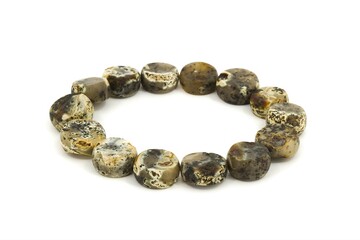 Handmade Baltic amber jewelry bracelet made of chalk amber stones on white background