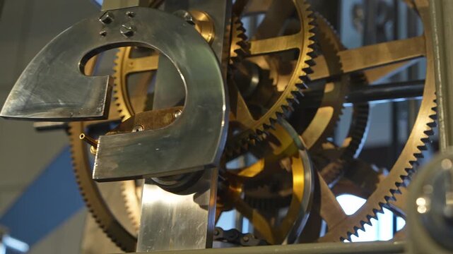 Close up of rotating clock gears and moving mechanical parts without clock face. Time mechanism, engineering precision, teamwork and process concept. Business, technology themes
