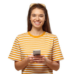 Portrait of beautiful young female holding smartphone, looking at camera and smiling, isolated on yellow