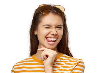 Playful young woman winking and sticking tongue out, wearing yellow striped shirt and sunglasses