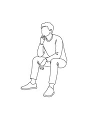Obraz premium Young man sitting thoughtfully, wearing casual clothing 