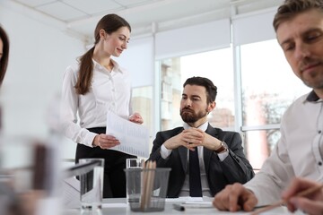 Businesspeople working together at table in office